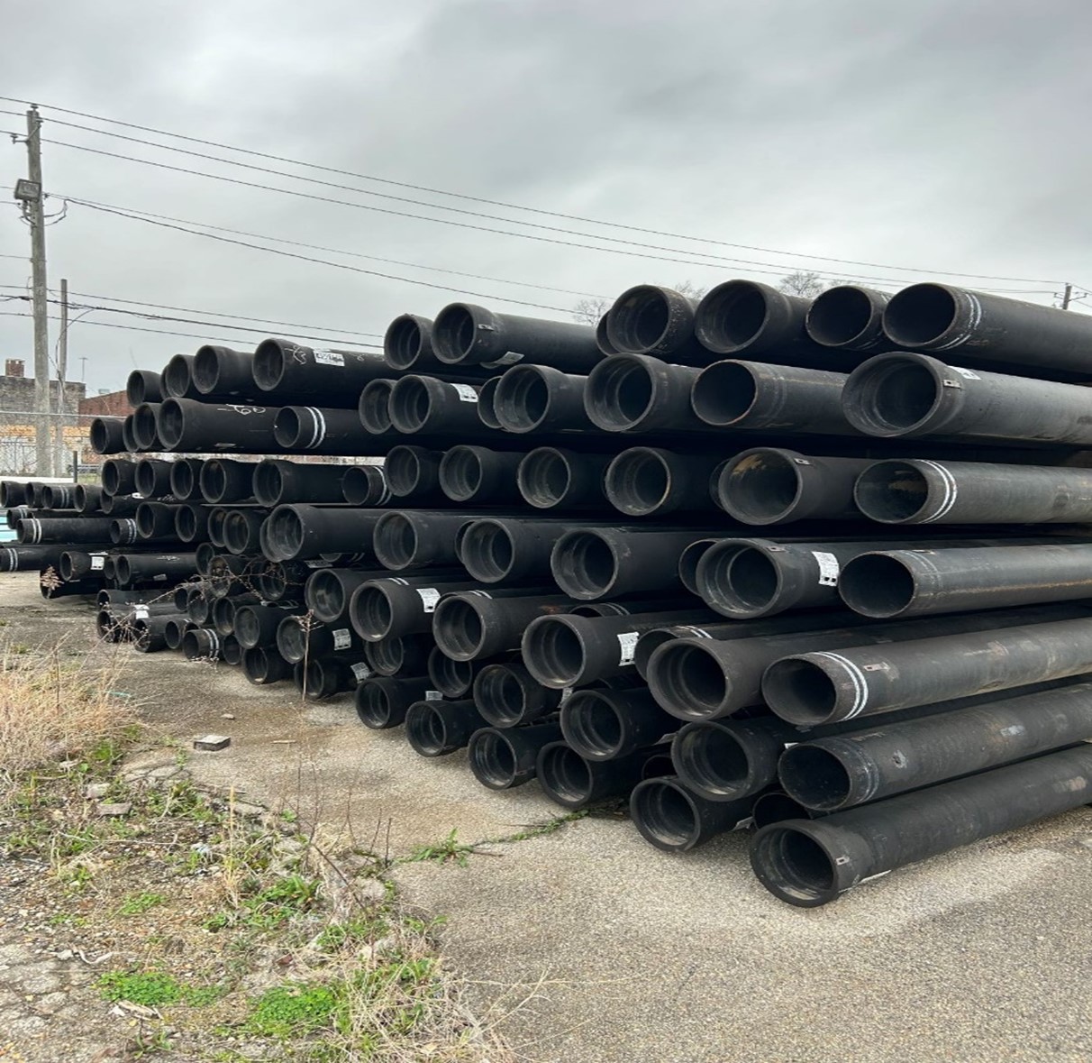 A large stack of Black Ductile Iron Water Pipe